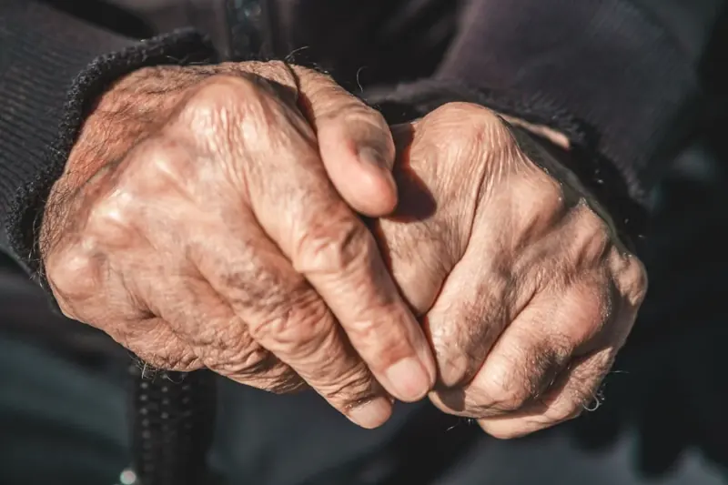 Hands resting together, representing care